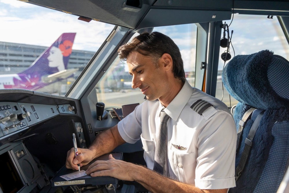 Pilot signing a pilot trading card