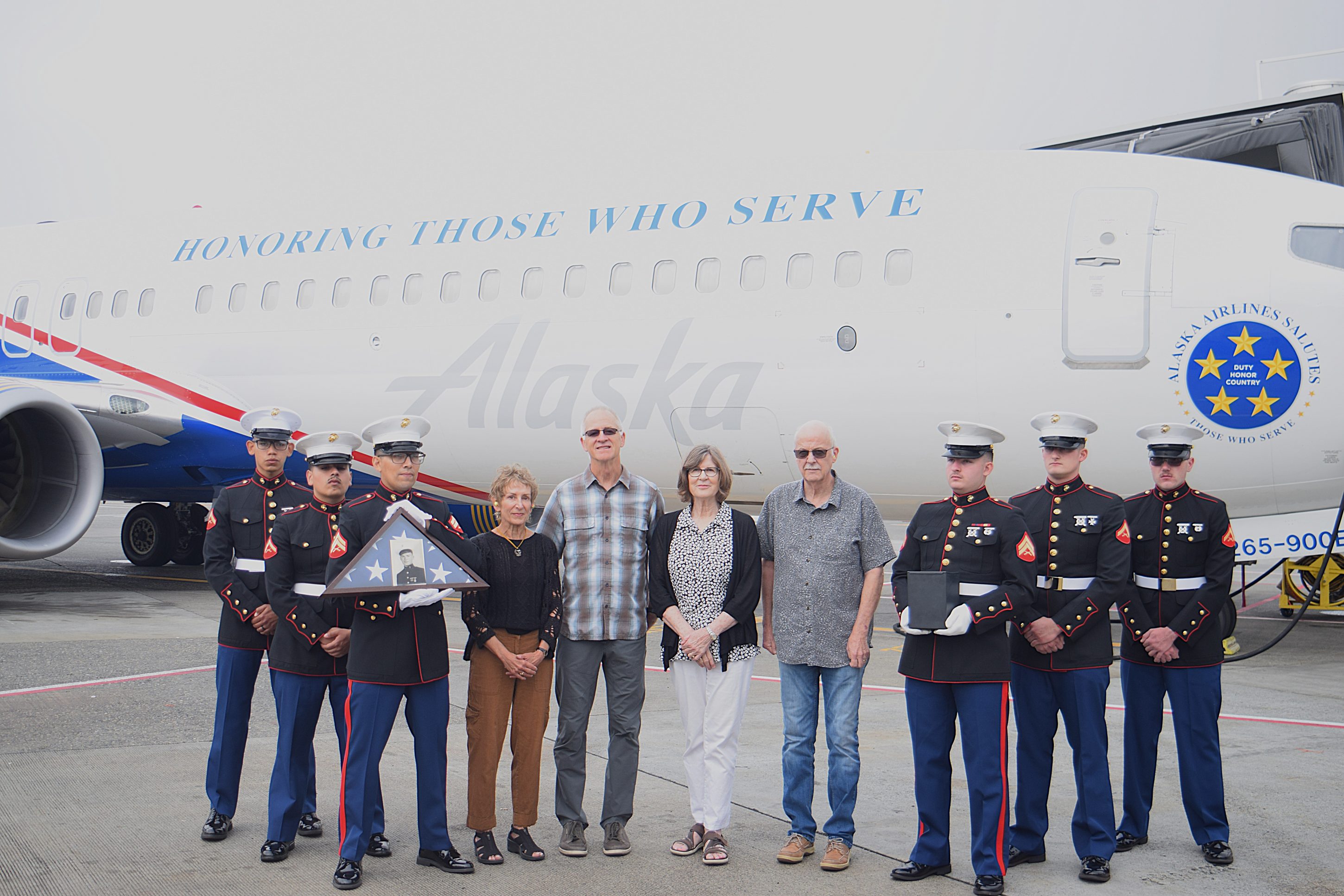 Honor flight image in front of military commemorative aircraft